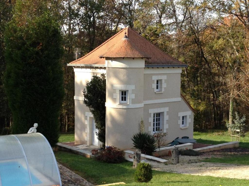 a small white house with a brown roof at Gîte de Caractère avec Piscine Privée dans Parc Arboré Proche Châteaux de la Loire - FR-1-491-376 in Angé