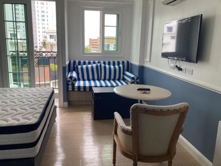 a living room with a couch and a table at room in Nong Prue