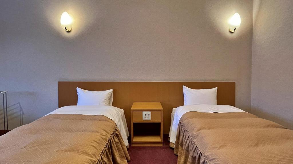 Postel nebo postele na pokoji v ubytování ペンション湖風 KOFU a lodging accommodation