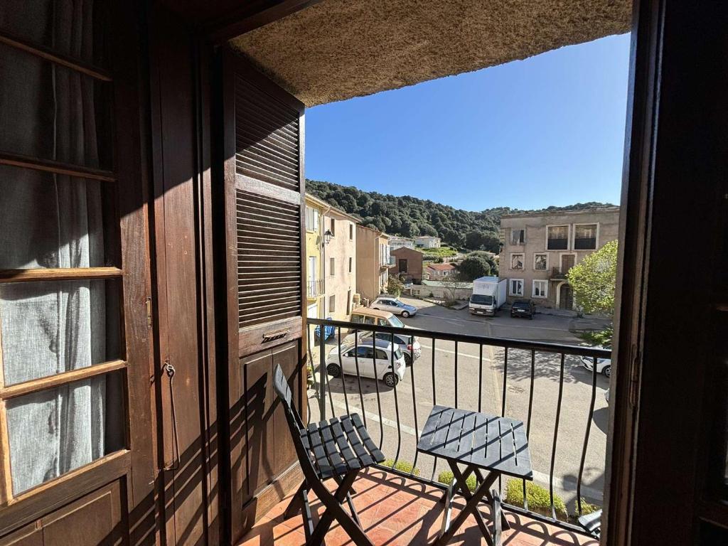 a balcony with a chair and a view of a street at Appartement Alata, 3 pièces, 4 personnes - FR-1-61-628 in Alata