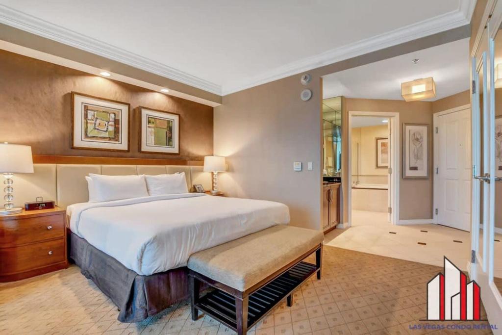 a large bedroom with a large bed and a hallway at MGM Signature-23-811 F1 Track & Strip View Studio in Las Vegas