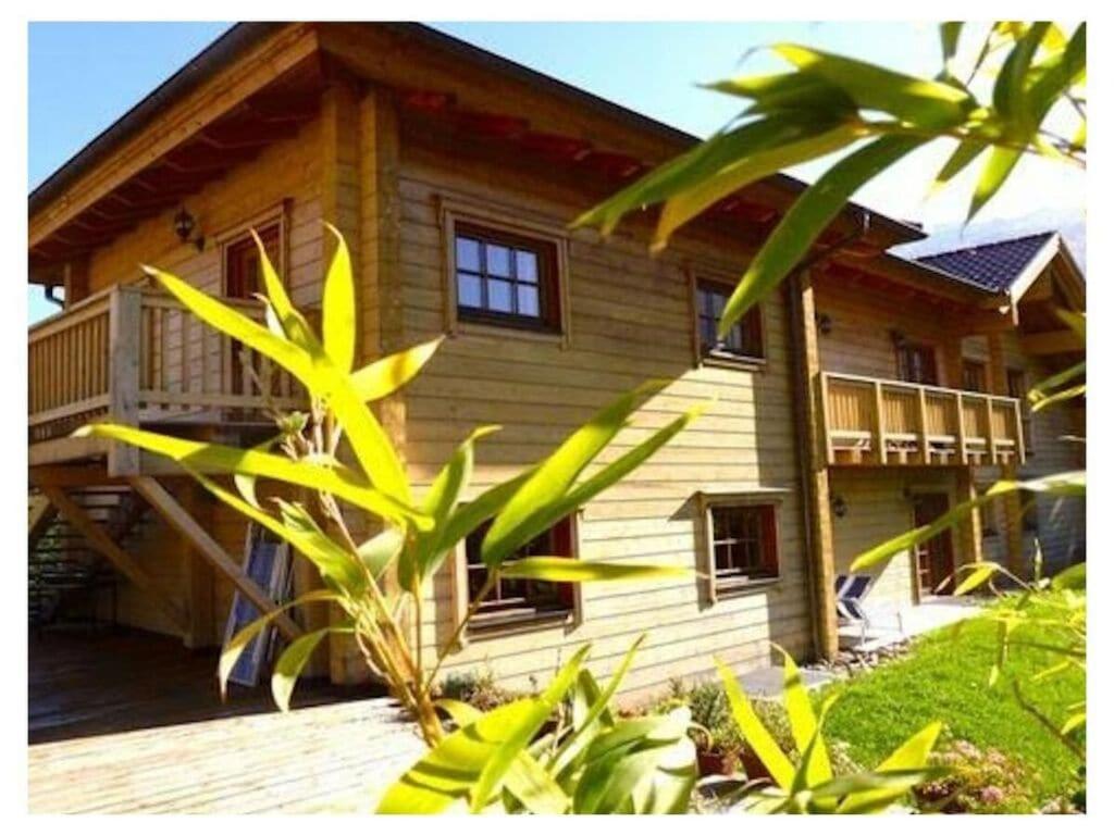 a large wooden house with a porch and a balcony at Pleasant apartment in Naturns in Naturno