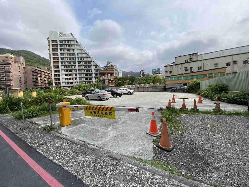 a parking lot with a caution sign and cones at Ashare Hotel in Jiaoxi