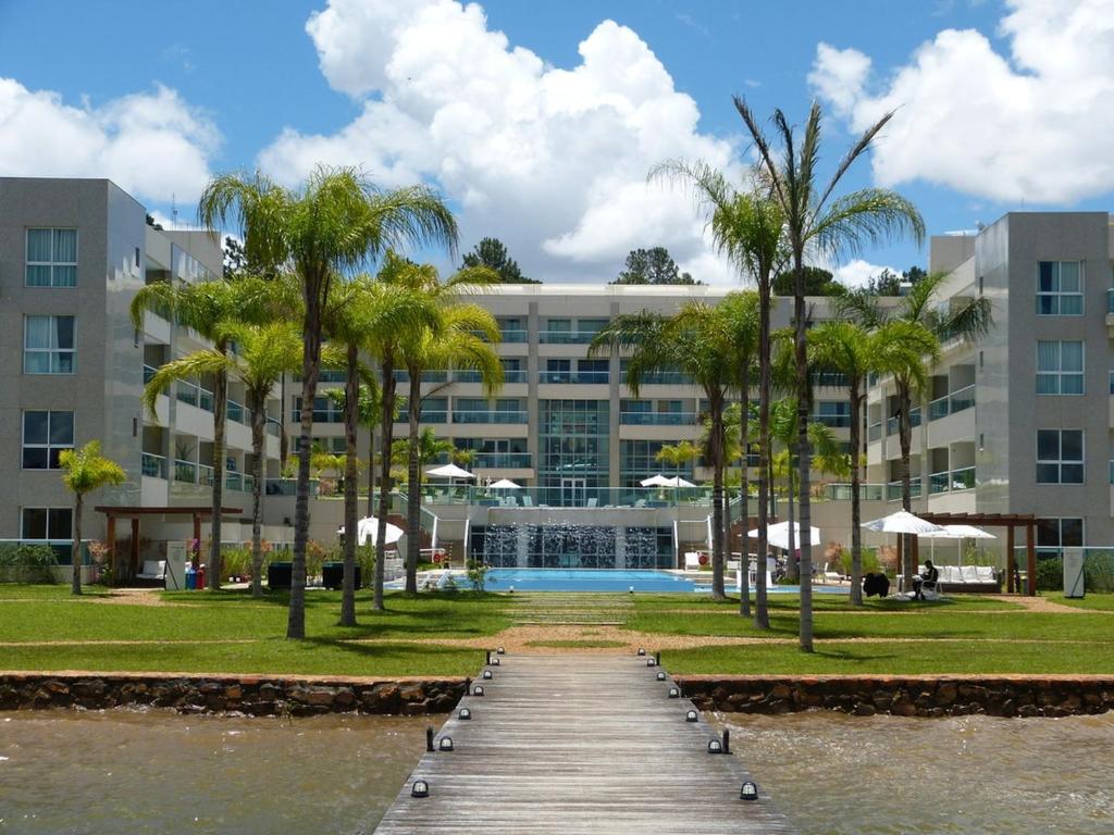 a resort with a boardwalk in front of a building at Alugueasy - Brisas do Lago in Brasília