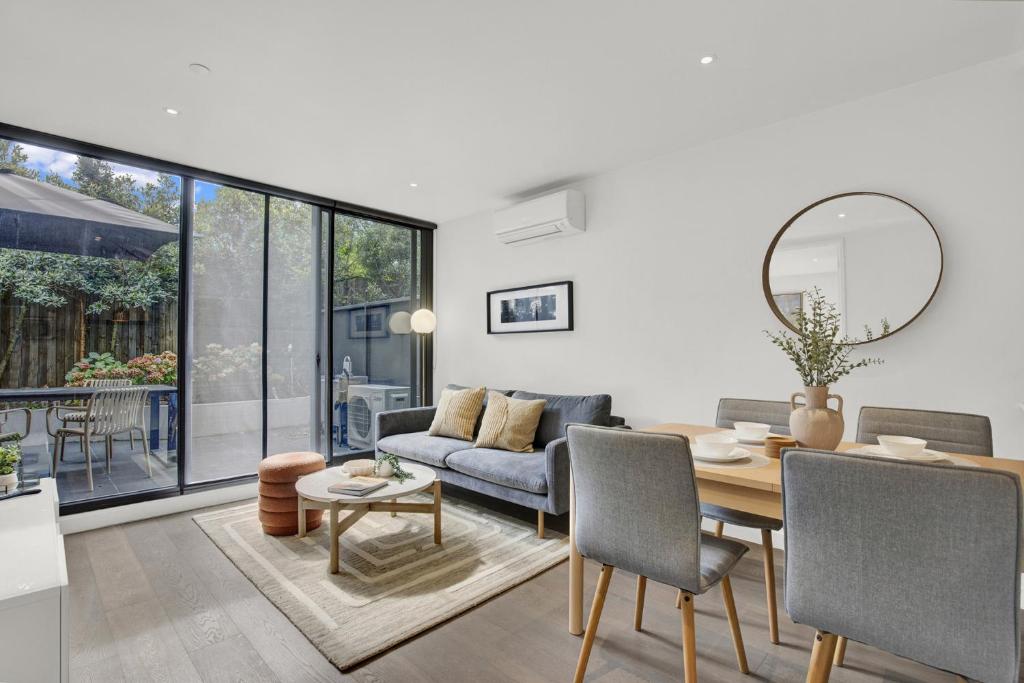 a living room with a table and a couch at Sophisticated 2-Bed by St Kilda Botanical Gardens in Melbourne