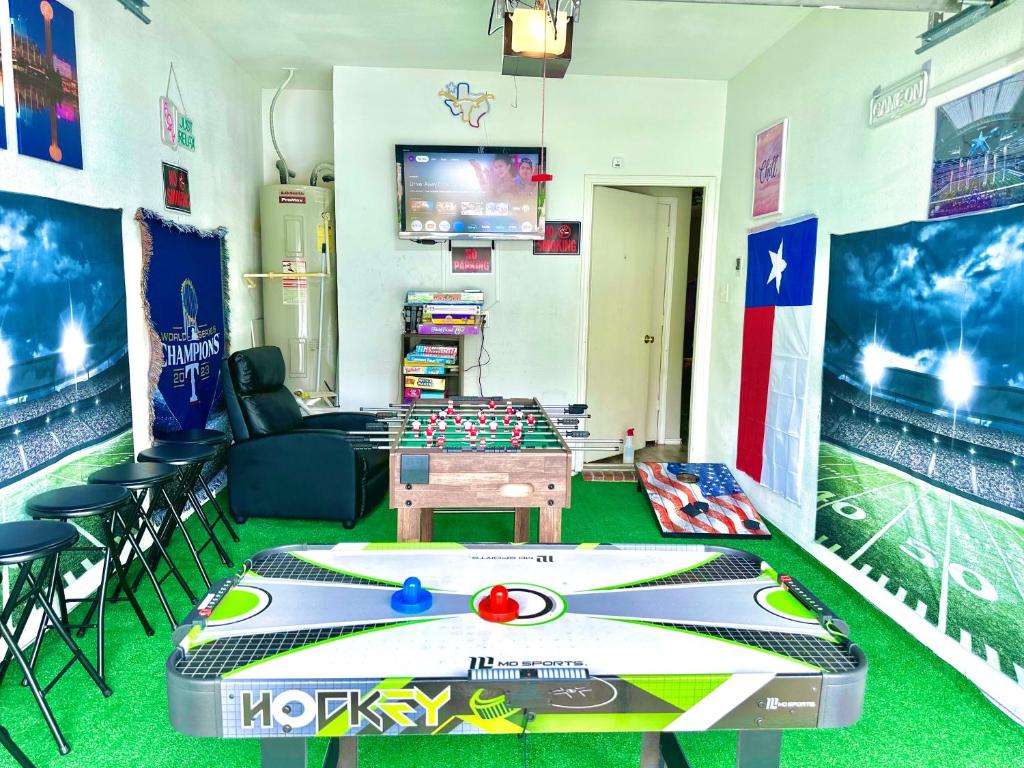 a room with a table and a game table at A Blissful Townhome with a Game Room Near AT&T Stadium, Six Flags, DFW Airport in Arlington