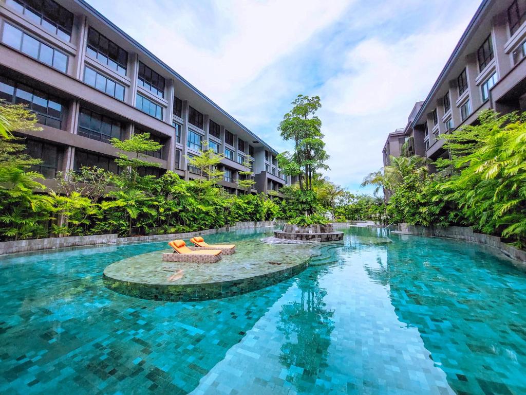 a swimming pool in the middle of a building at Pearl Nusa Dua Suite in Nusa Dua