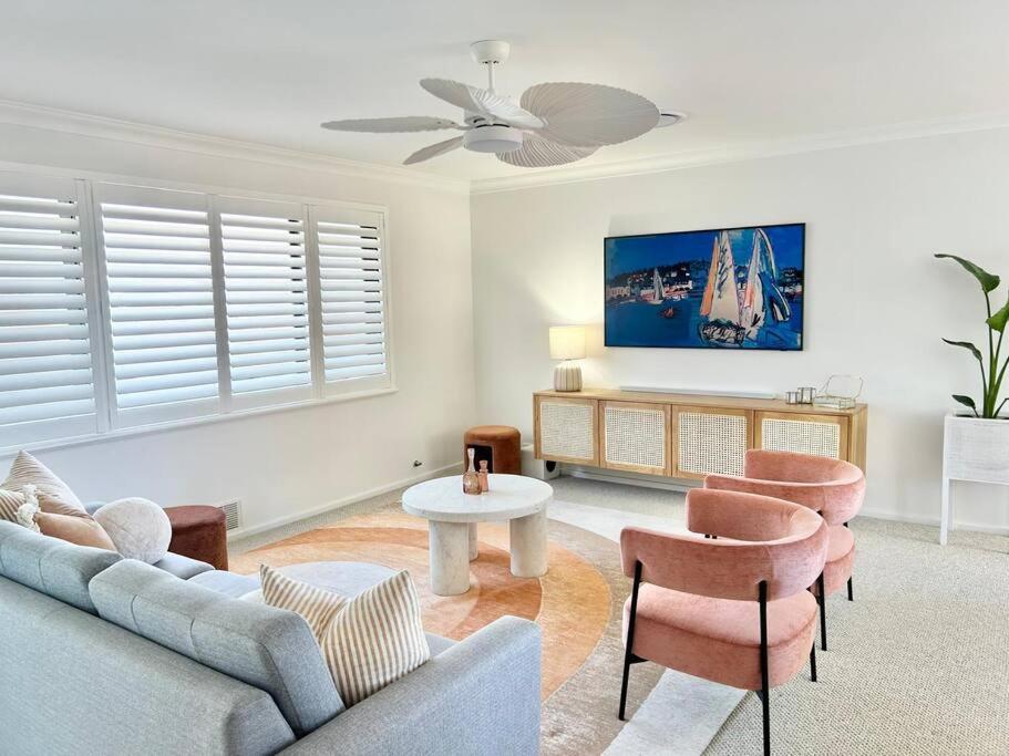 a living room with a couch and chairs and a tv at Dolce Vista - North Beach Coastal Haven in Perth