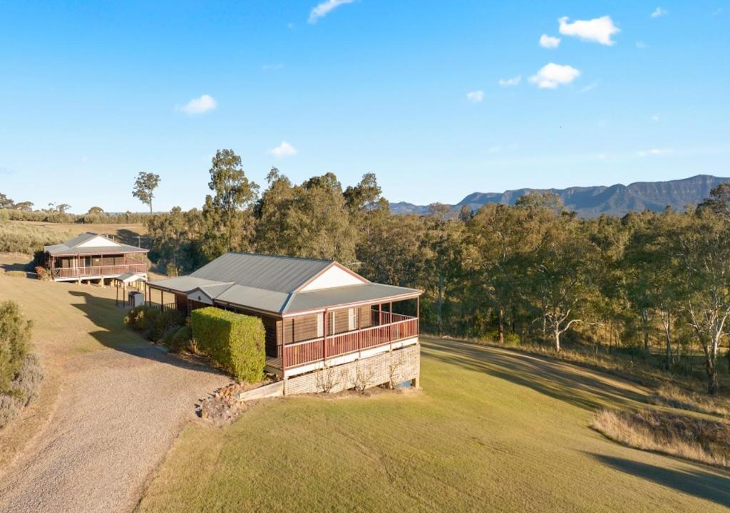 an aerial view of a house on a grass field at North Lodge Highland Cottage in Pokolbin