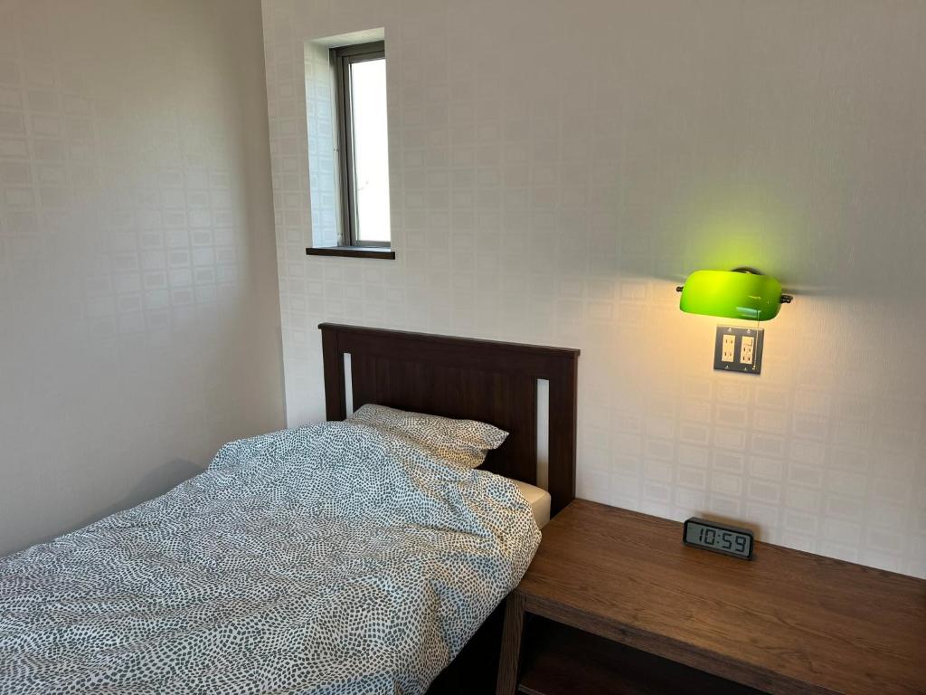 Postel nebo postele na pokoji v ubytování 仁昌堂ホテル
