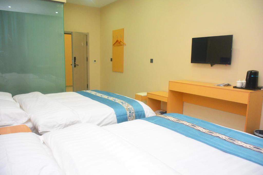 Postel nebo postele na pokoji v ubytování Hongge Hotel - Harbin Taiping Airport