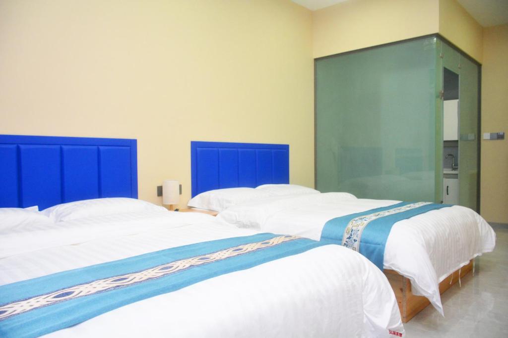 Postel nebo postele na pokoji v ubytování Hongge Hotel - Harbin Taiping Airport