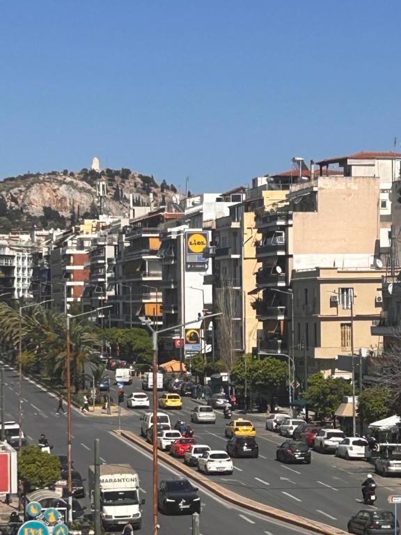 a busy city street filled with cars and buildings at O live Athens in Athens