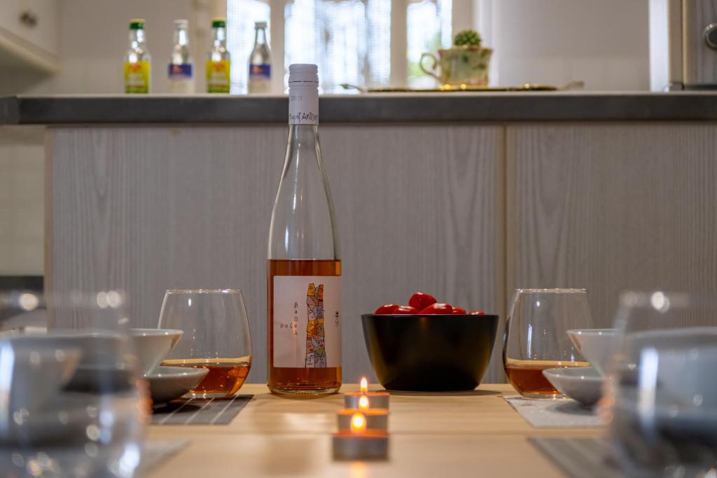 a bottle of wine sitting on a table with glasses at Stefano's Home in Potokáki