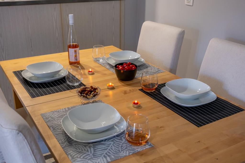 a table with plates and glasses and candles on it at Stefano's Home in Potokáki
