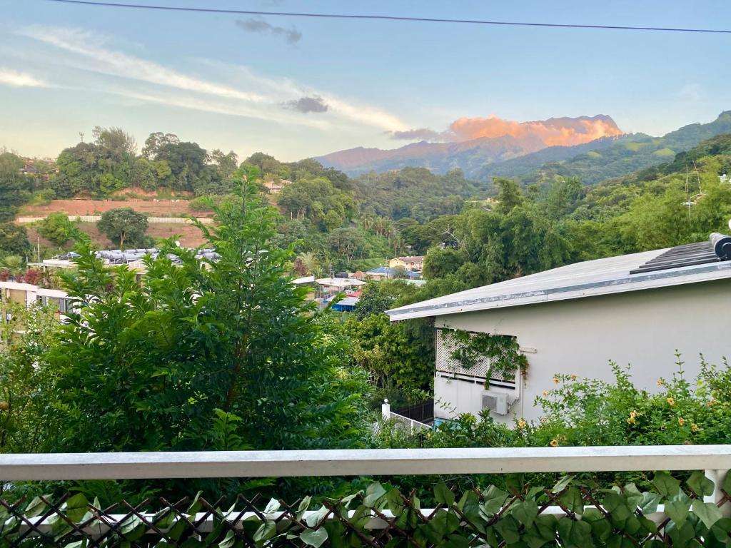 a view of a city with mountains in the background at Heiata Lodge Papeete in Papeete