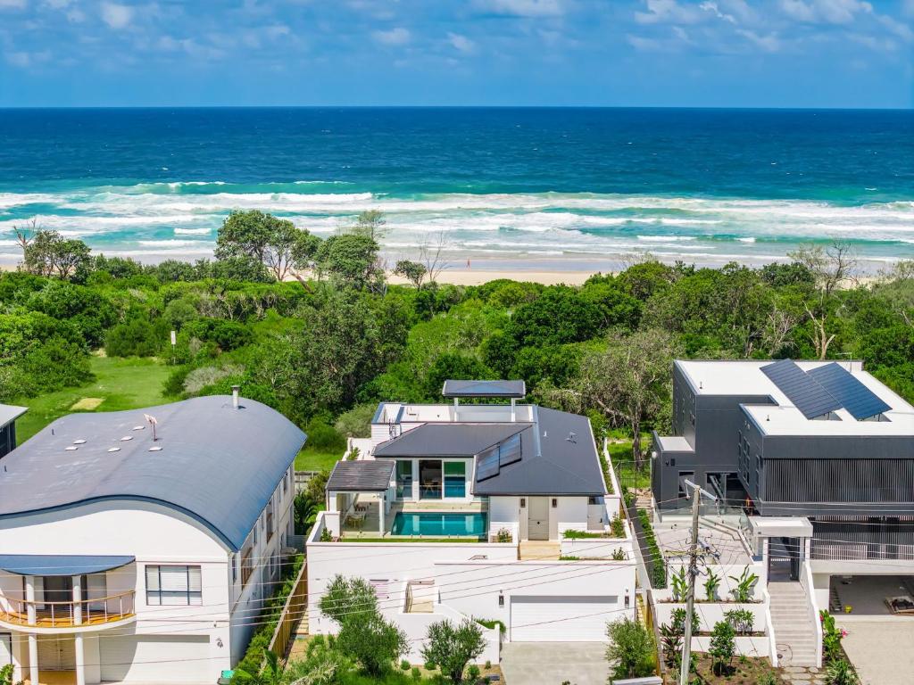an aerial view of a house and the beach at Aquarium House - with direct beach access & pool in Pottsville