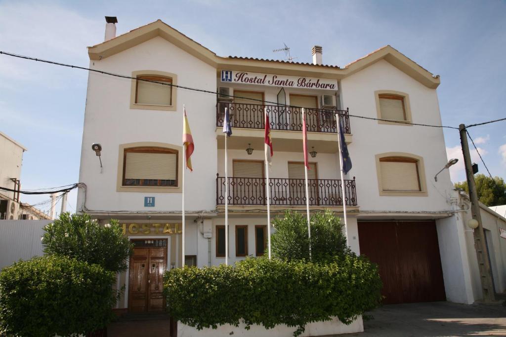 a building with flags in front of it at Hostal Santa Barbara in Socuéllamos