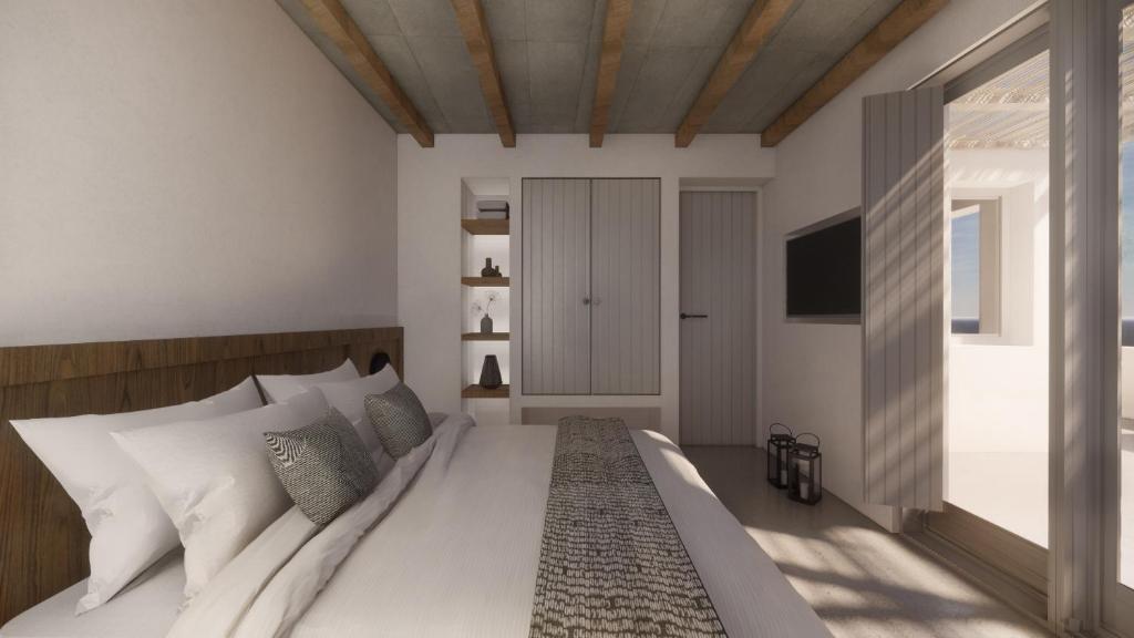 a bedroom with a large white bed and a television at Seascape, apartment 5 with sea view in Áno Meriá