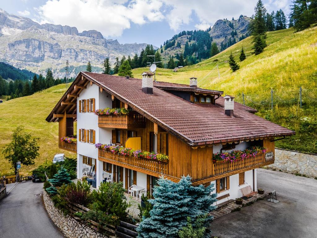 a house in the mountains with flowers on the balconies at Chalet Pradat in Arabba