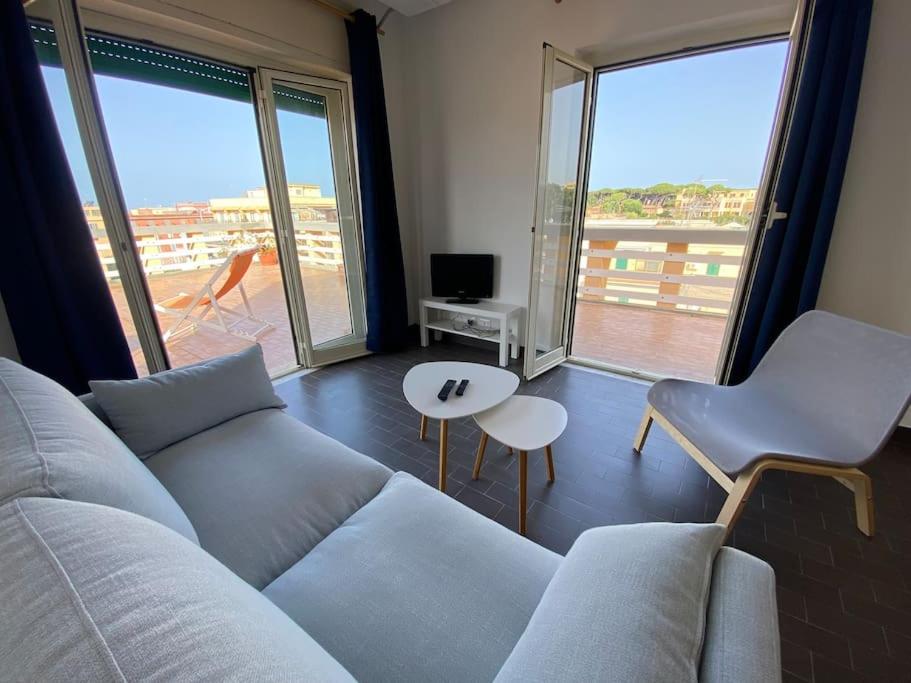 a living room with a couch and a large window at La terrazza sul porto in Anzio