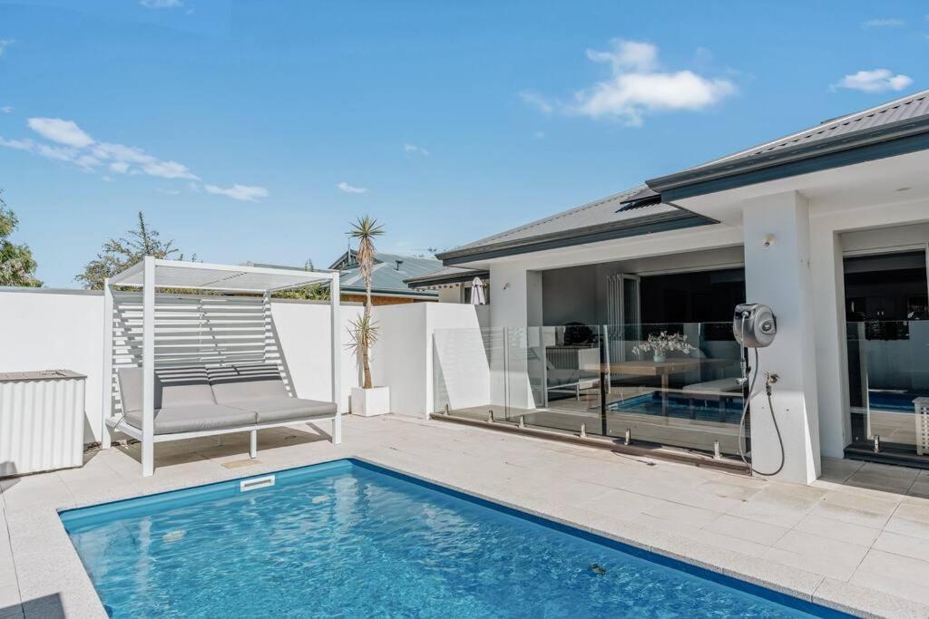 a swimming pool in front of a house at Sundrift: Tranquil Retreat with Spectacular Views in Quindalup