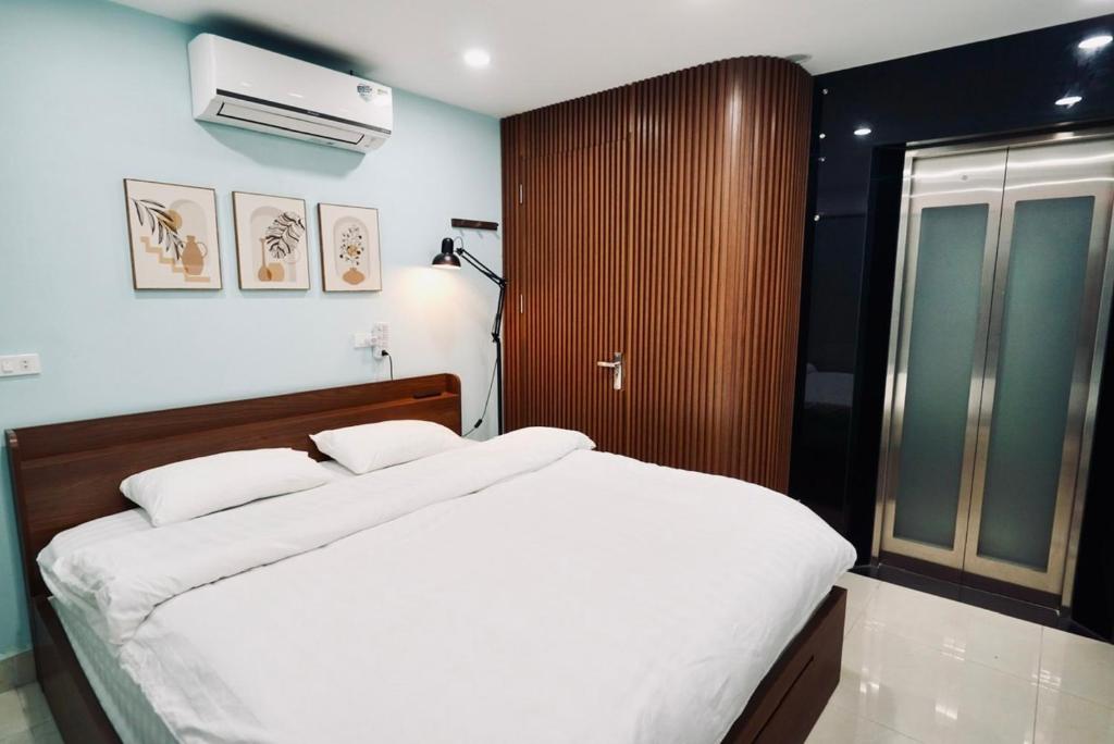 a bedroom with a bed and a air conditioner at Niah Cozy Home - Train Street in Hanoi