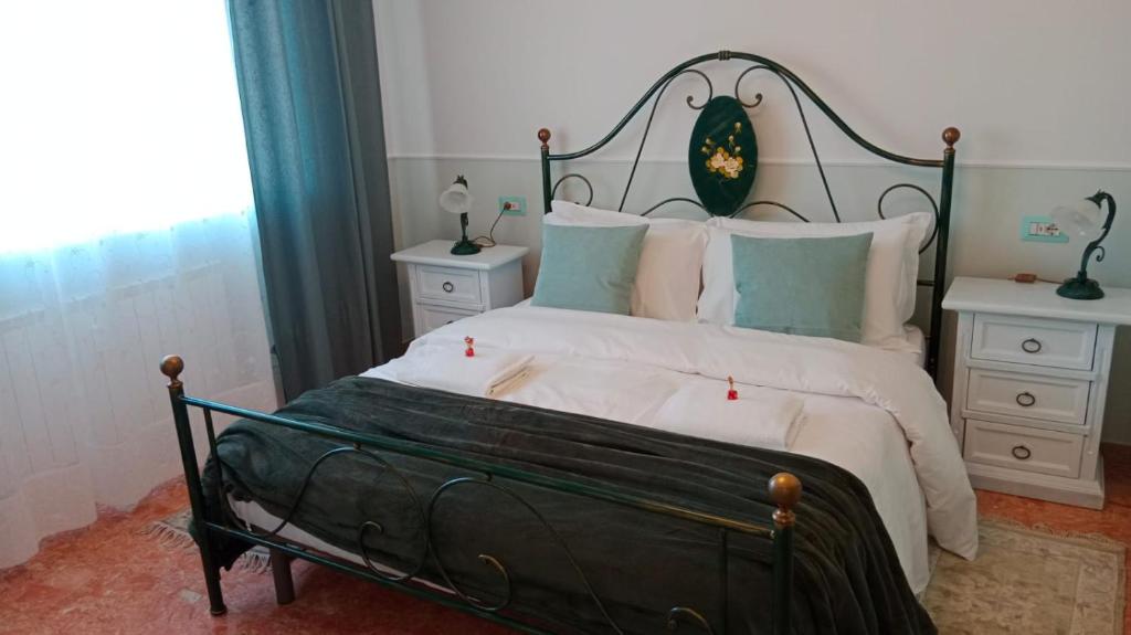 a bedroom with a black and white bed with two night stands at SOFIA in Venice