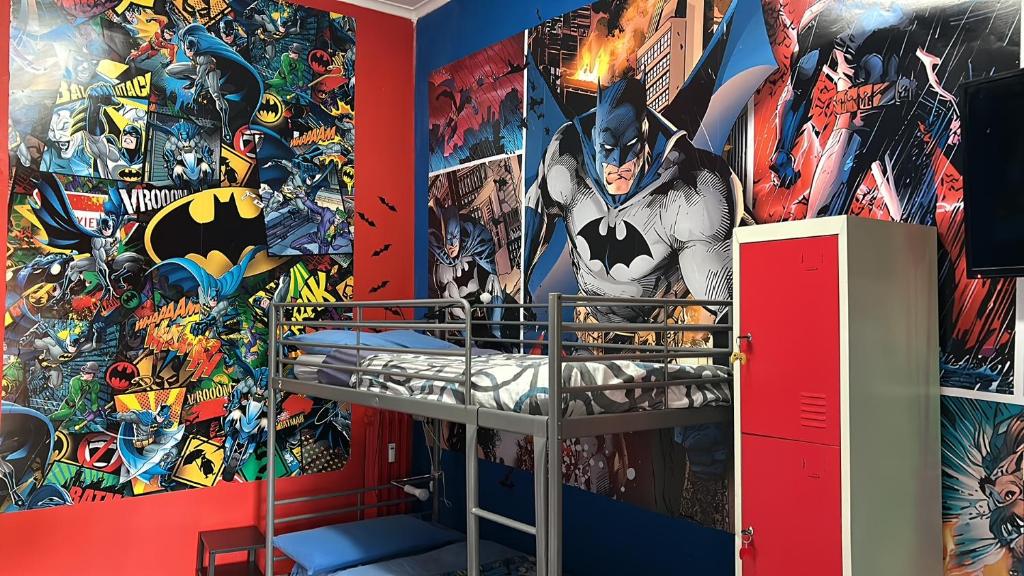 a bedroom with a superhero mural on the wall at Comics Guesthouse Hostel in Rome