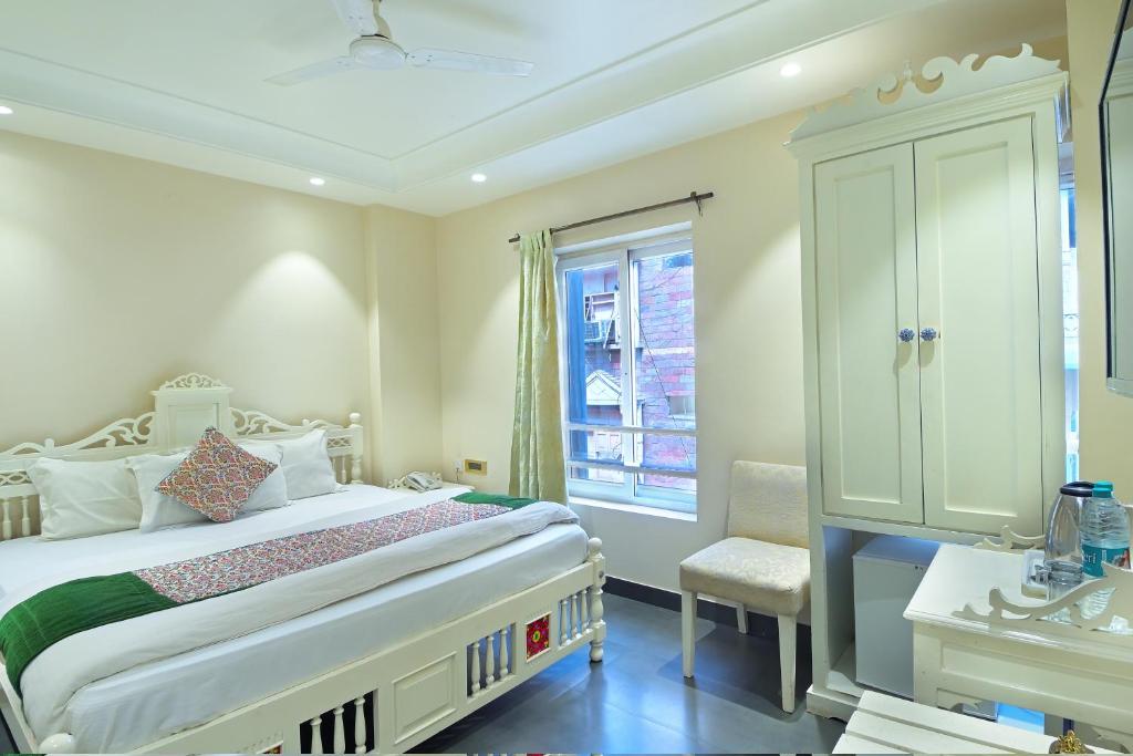 a bedroom with a large bed and a window at Hotel Pinky Villa - Paharganj I New Delhi Railway Station in New Delhi