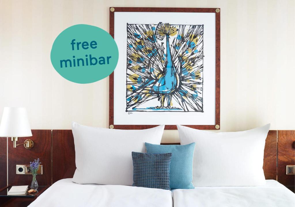 a bedroom with a bed with a picture of a blue bird at Living Hotel Berlin Mitte in Berlin