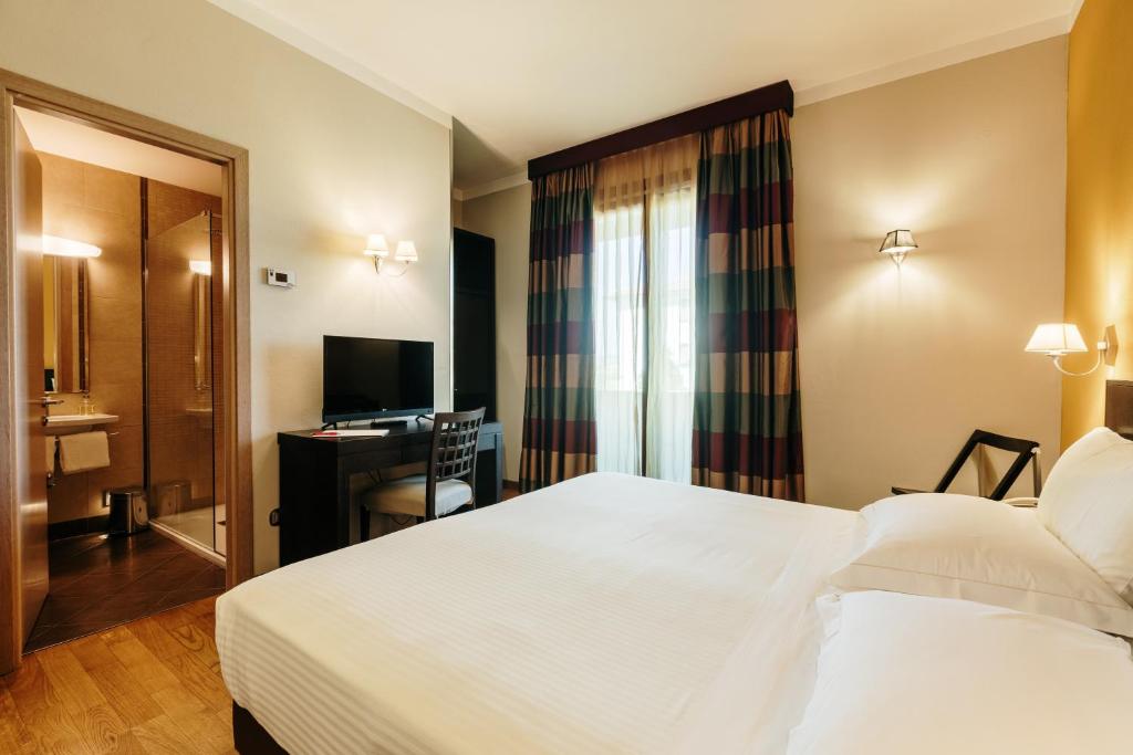 Postel nebo postele na pokoji v ubytování Hotel Dei Vicari