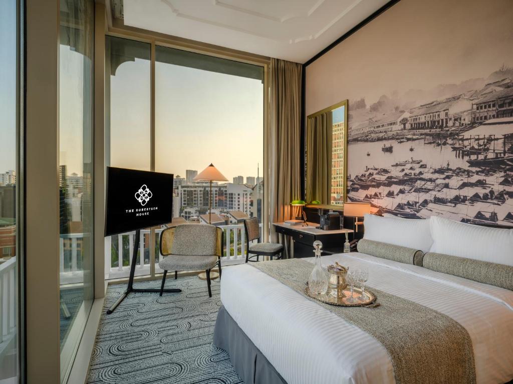 a hotel room with a bed and a large window at The Robertson House managed by The Ascott Limited in Singapore