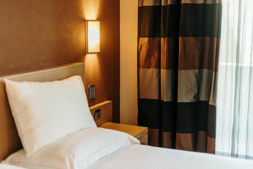 Postel nebo postele na pokoji v ubytování Hotel Dei Vicari