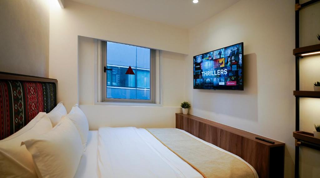 Giường trong phòng chung tại ST Signature Bugis Middle, SHORT OVERNIGHT, 11 hours 8PM-7AM
