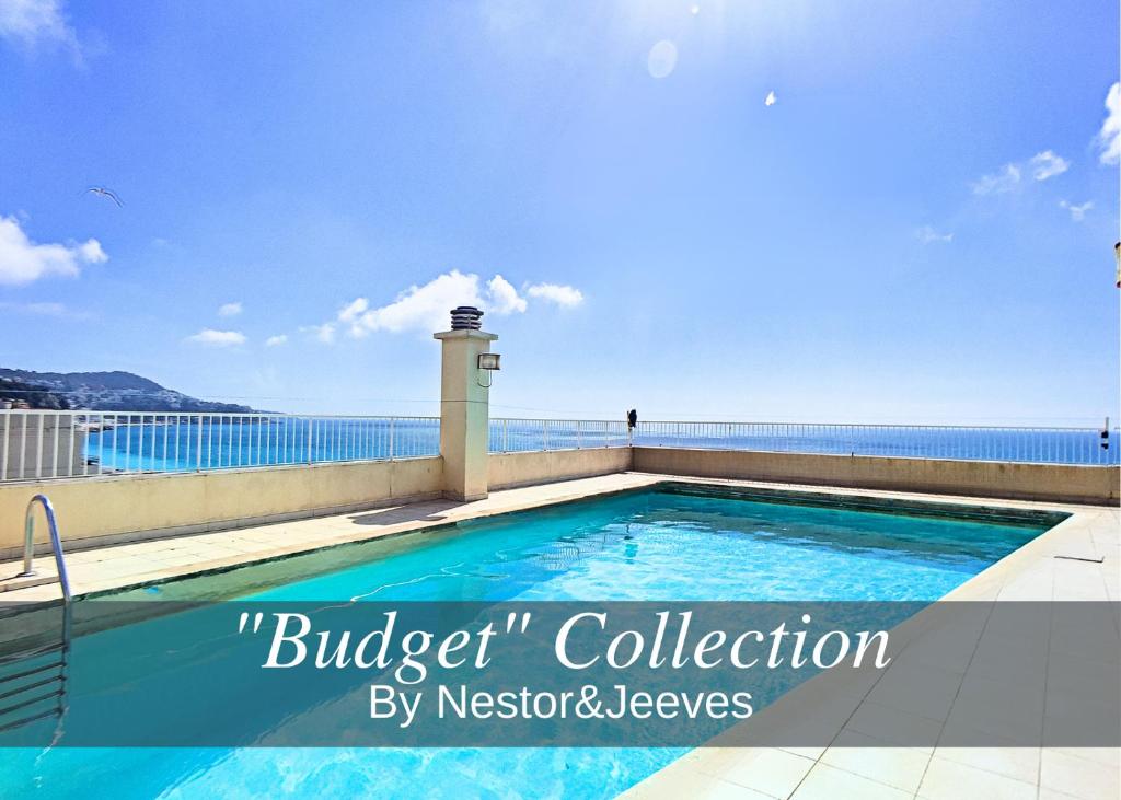 a swimming pool on a balcony with the ocean in the background at Nestor&Jeeves - SUITE ROYAL LUXEMBOURG - Central - Swimming pool on roof in Nice