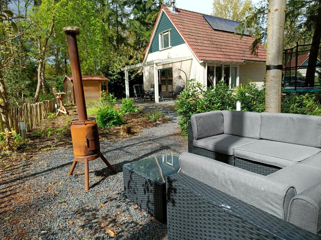 a living room with a couch and a wood stove at Bosvilla Lochem in Lochem