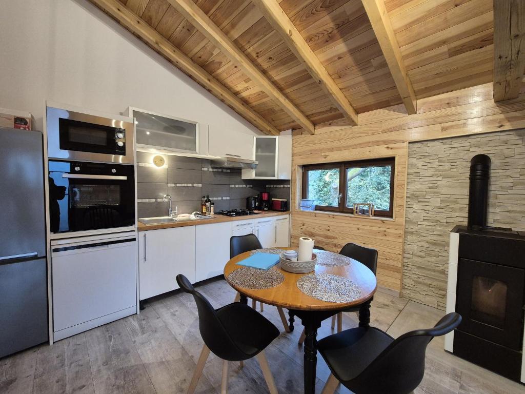 a kitchen with a table and chairs in a room at Le Chalet Cocon in La Petite-Pierre