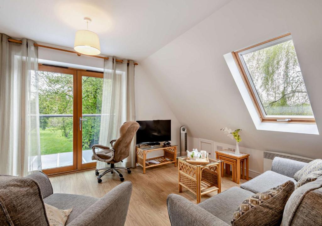 a living room with a couch and a tv at Little Coach House 