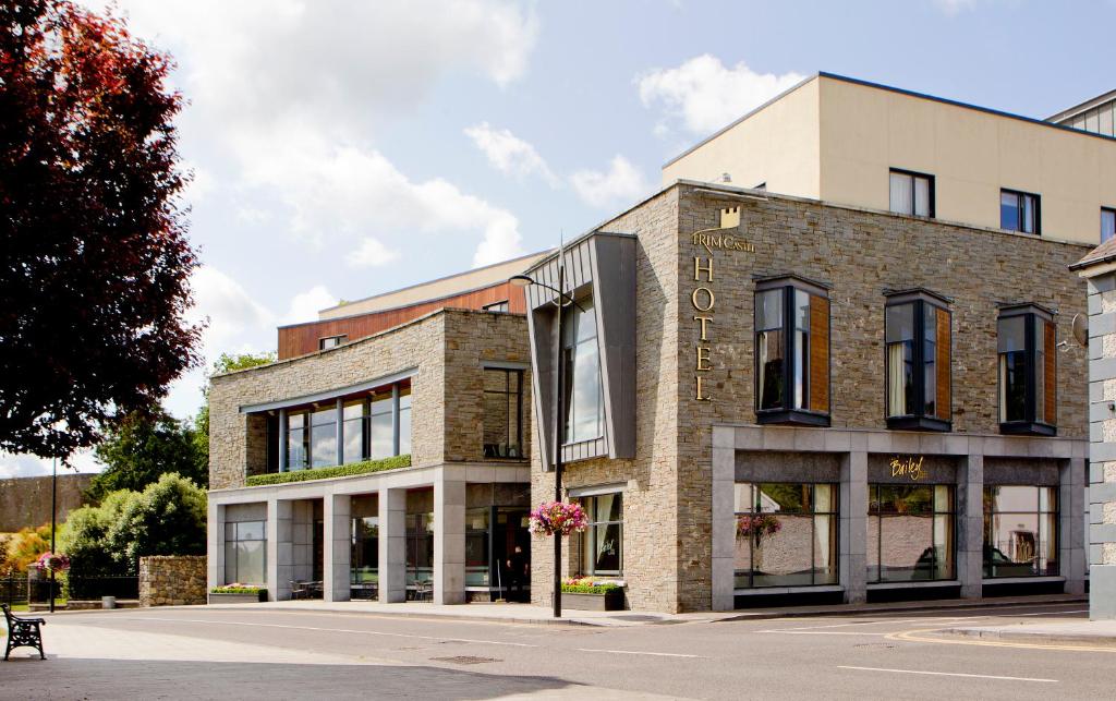 a brick building with a sign on the front of it at Trim Castle Hotel in Trim