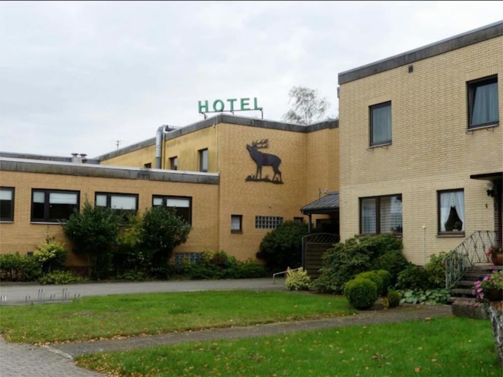 a hotel with a sign on the side of a building at Hotel-Restaurant Hubertus in Brome