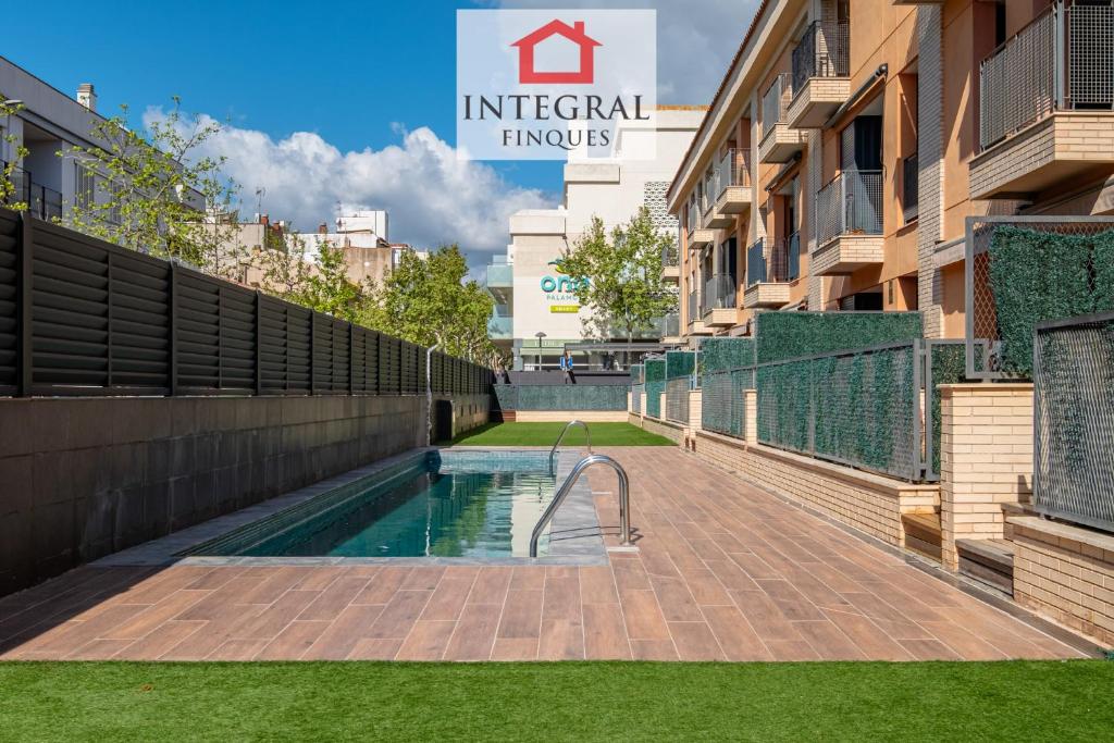 a swimming pool in the courtyard of a building at Dive Palamós in Palamós