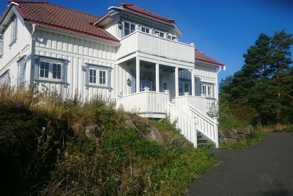 a large white house with a red roof at Big Holiday House South of Norway, by the Osean in Gjeving