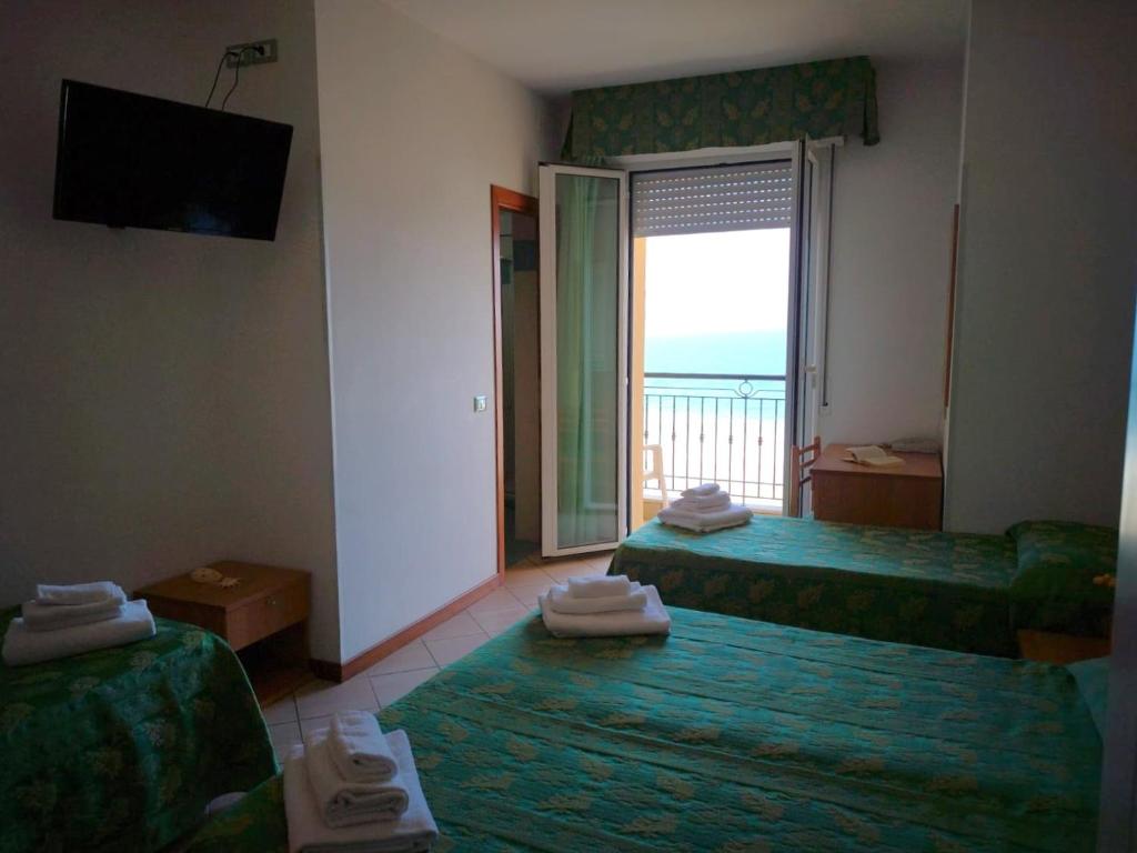 Postel nebo postele na pokoji v ubytování Hotel Belvedere