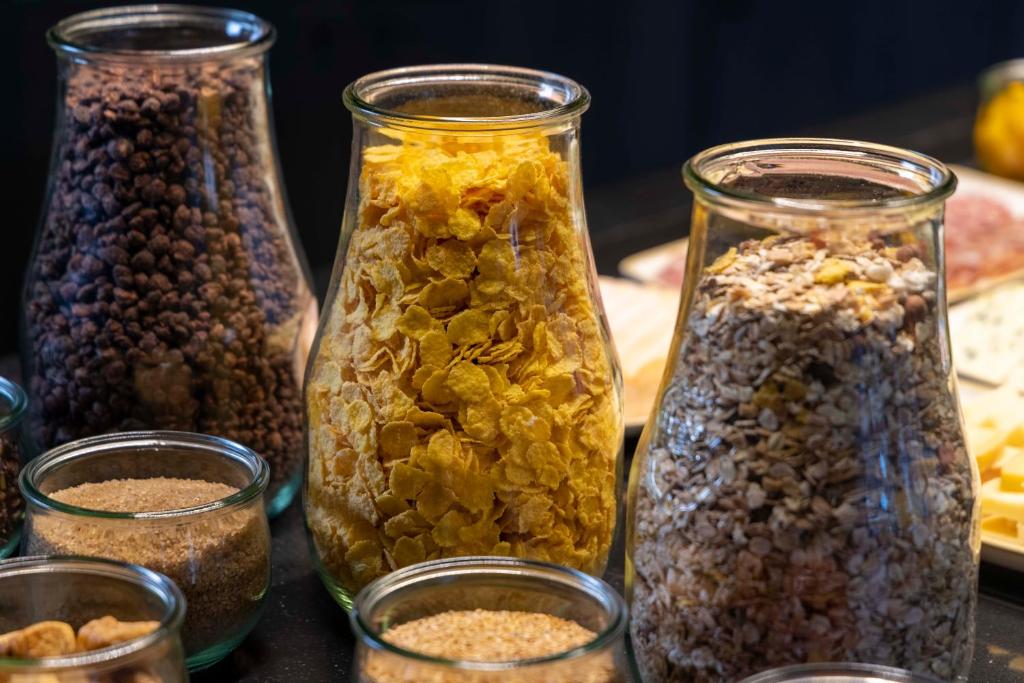 a group of glass jars filled with different types of nuts at Hotel D - Strasbourg in Strasbourg