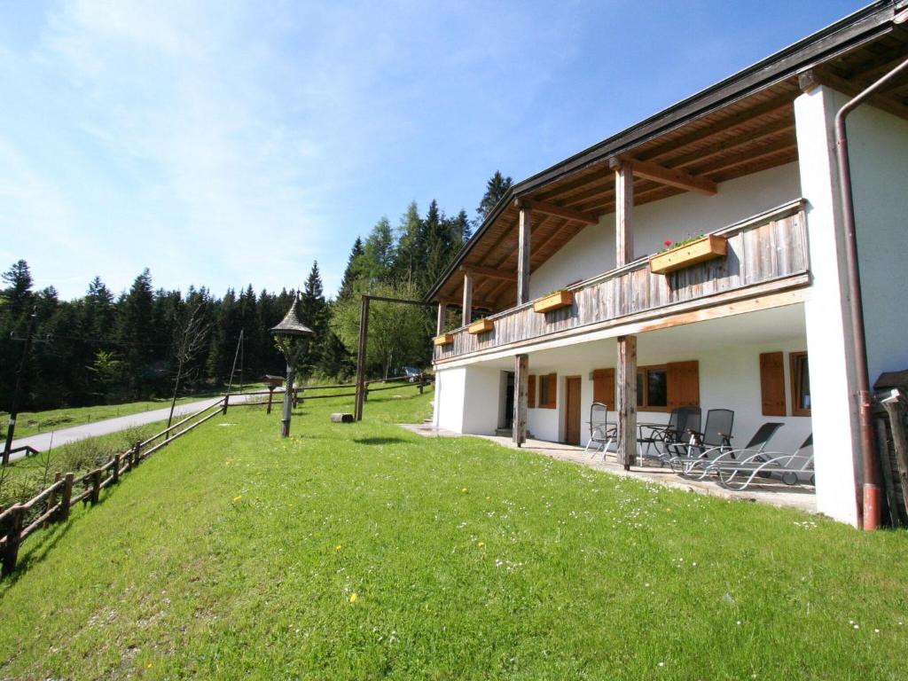 a house with a green lawn in front of it at Chalet in Niederndorf near Kufstein with balcony in Niederndorferberg