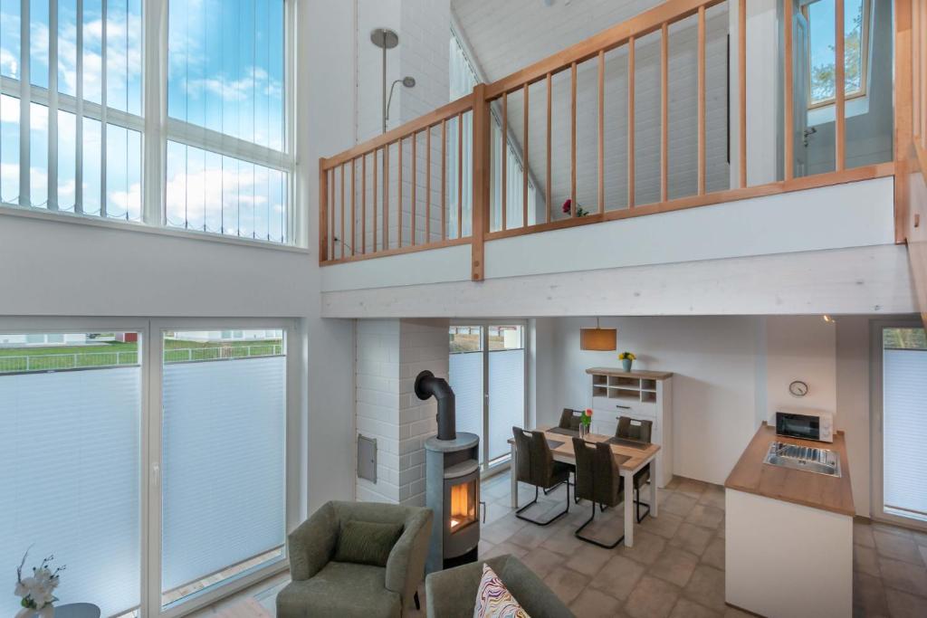 an open living room with a staircase and a living room at Ida - Nordhorn in Nordhorn