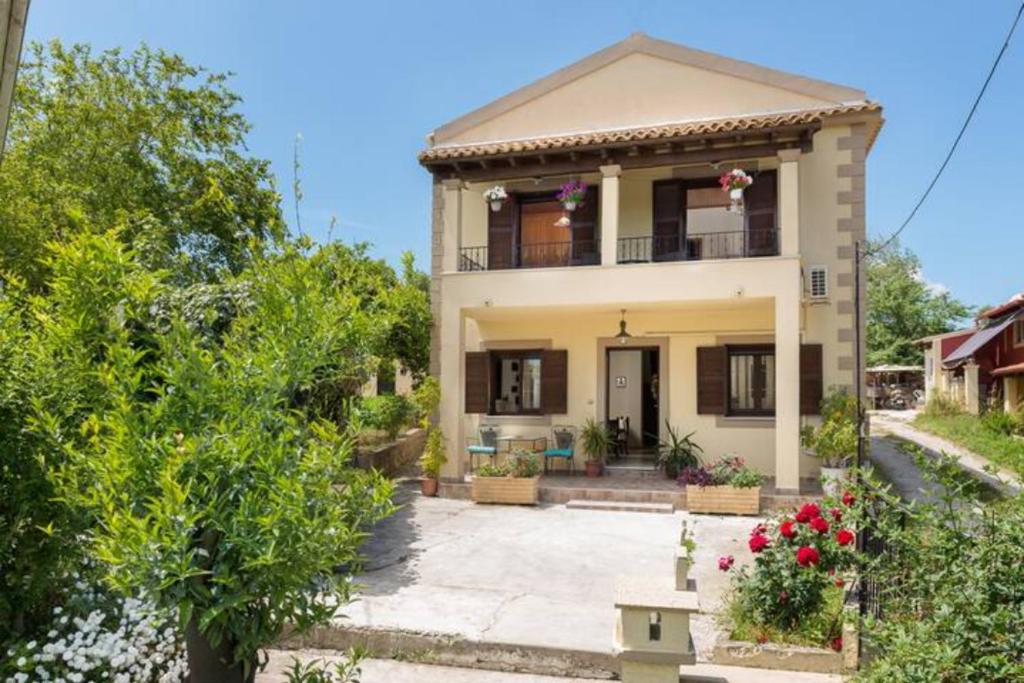 a house with a balcony and a yard at Antzela's Town House Corfu in Alepou