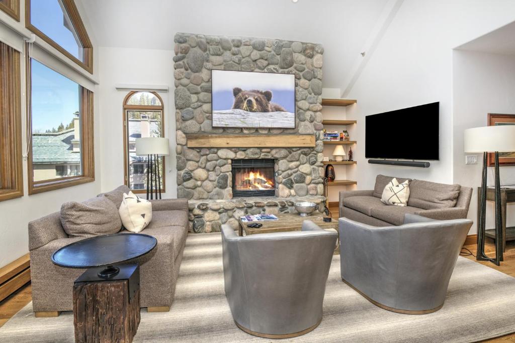 a living room with a stone fireplace and furniture at Highlands Westview 300 condo in Beaver Creek
