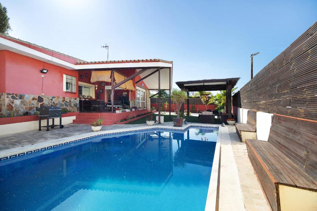 a swimming pool in front of a house at Goleta in El Puerto de Santa María